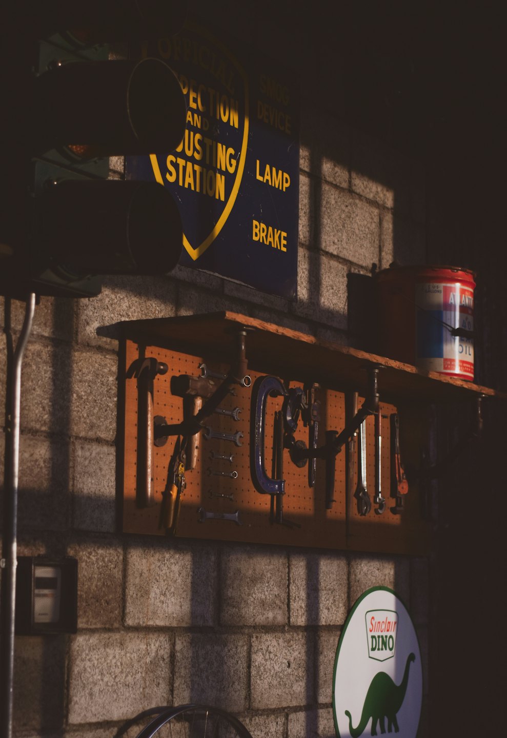 Vintage workshop wall with tools and antique motor signs.