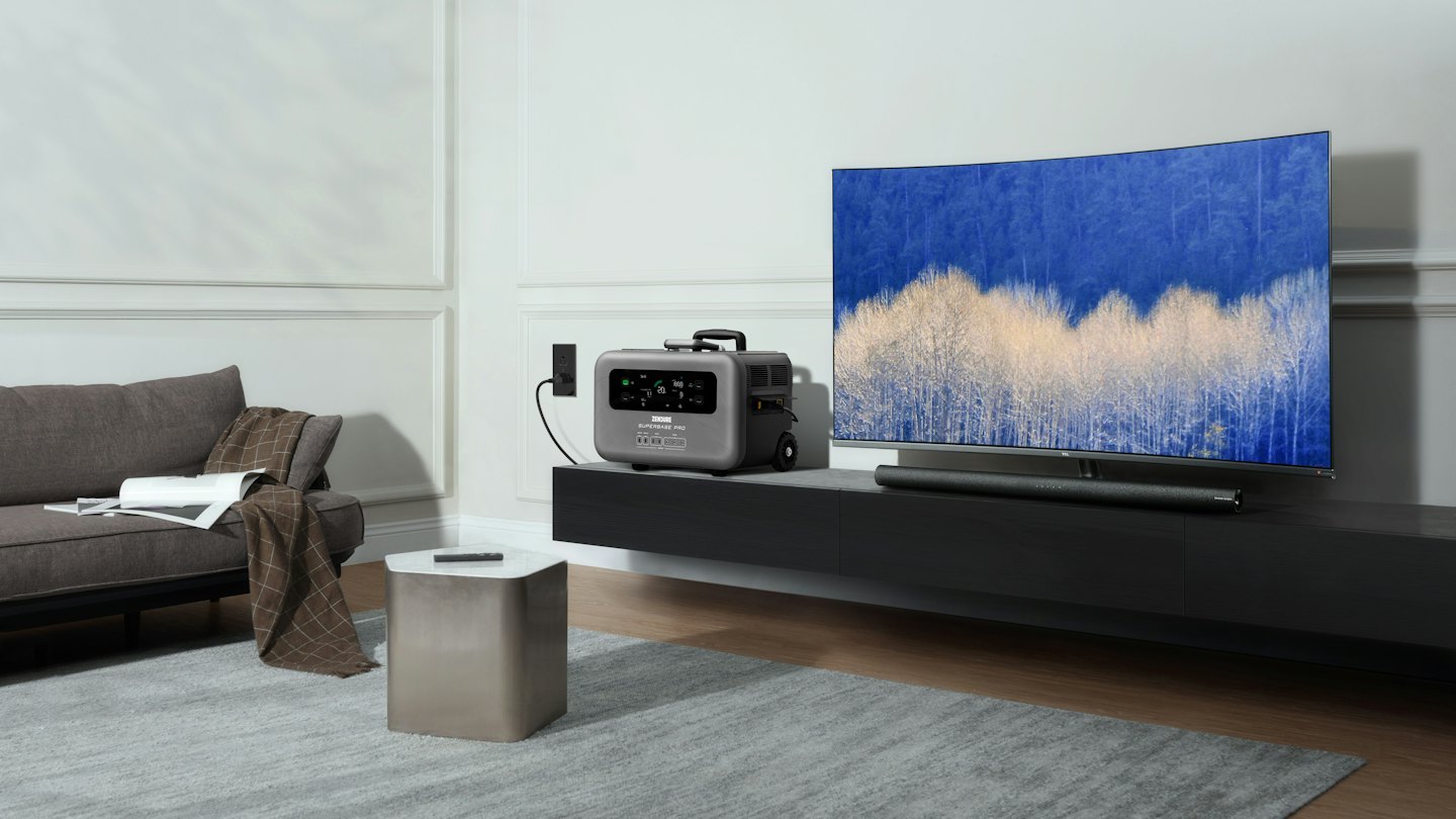 A grey portable power station charges on a modern console table.